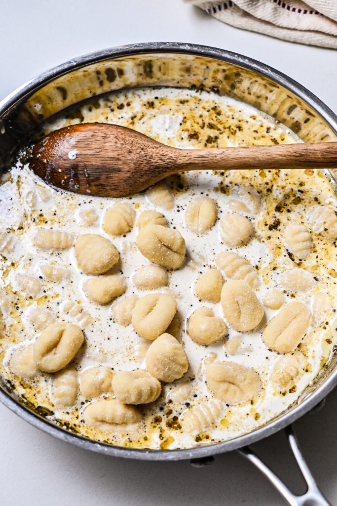 Cream, broth and ghocchi added to the pan.