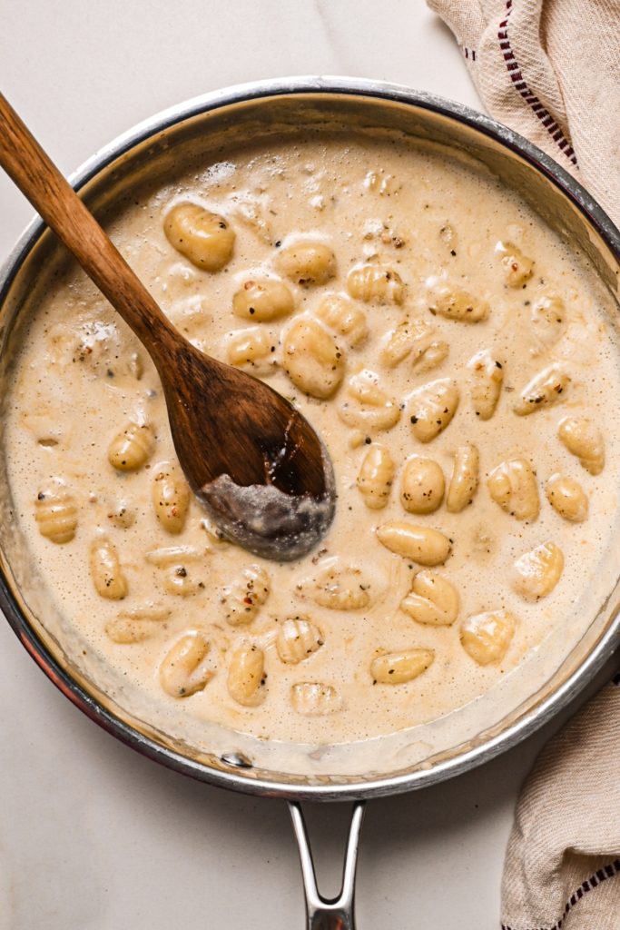Overhead shot of gnocchi au poivre cooking in a pan.