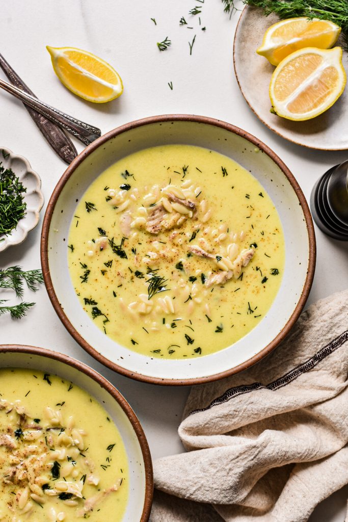 Overhead shot of creamy chicken orzo yogurt soup in a bowl.