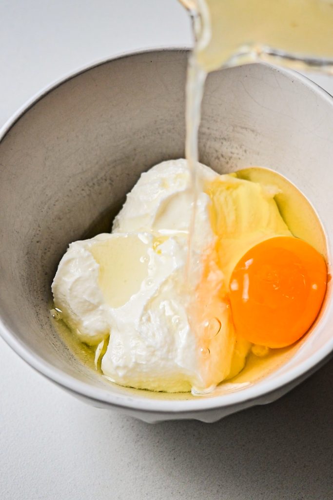 Combining yogurt, egg and lemon juice in a small bowl.