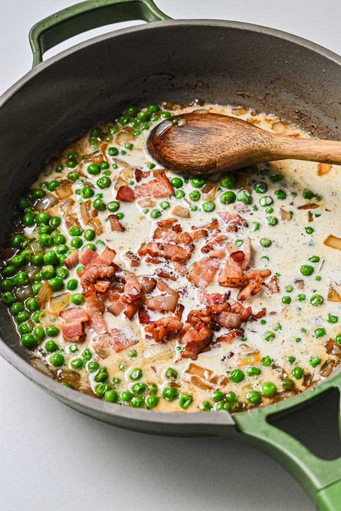 Bacon added back to the skillet with cream.