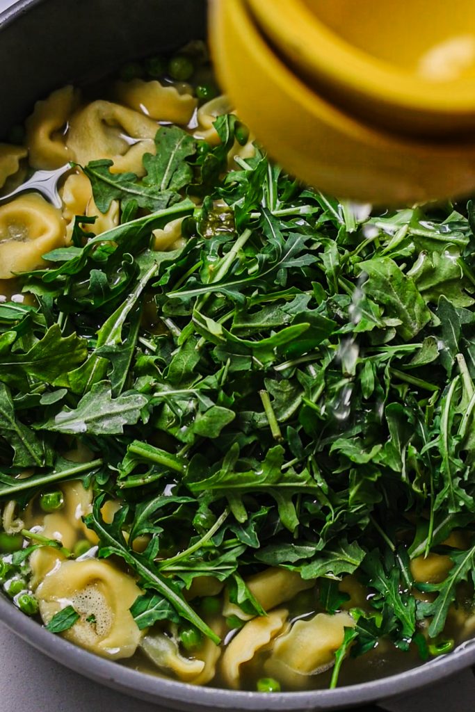 Arugula and lemon added to the broth and tortellini.